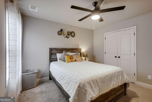 bedroom with light carpet, a closet, and ceiling fan