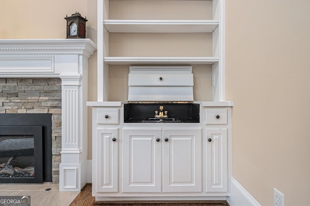 bar featuring a stone fireplace