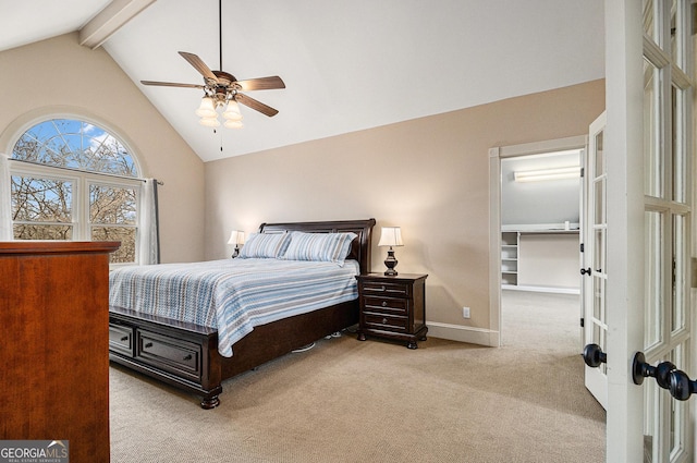 bedroom featuring carpet, a spacious closet, a ceiling fan, beamed ceiling, and baseboards