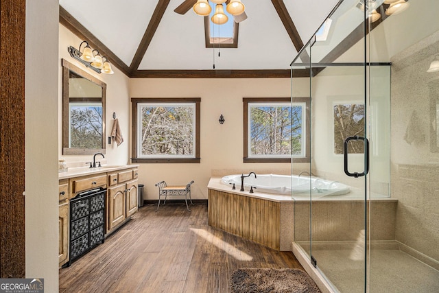 full bathroom with lofted ceiling, a stall shower, wood finished floors, and vanity