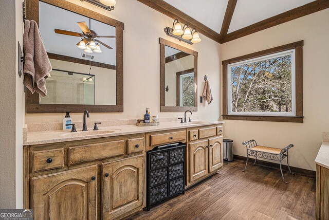 bathroom with double vanity, visible vents, a sink, and wood finished floors