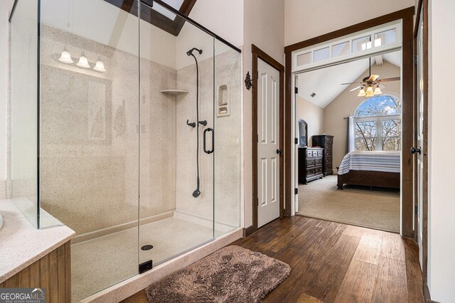 bathroom featuring vaulted ceiling with beams, a stall shower, connected bathroom, ceiling fan, and wood finished floors