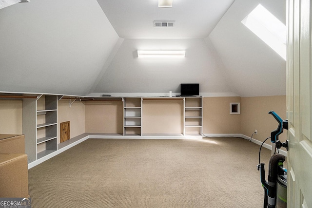 additional living space with lofted ceiling with skylight, carpet, visible vents, and baseboards