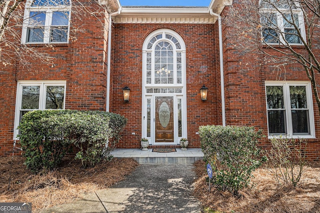 doorway to property with brick siding