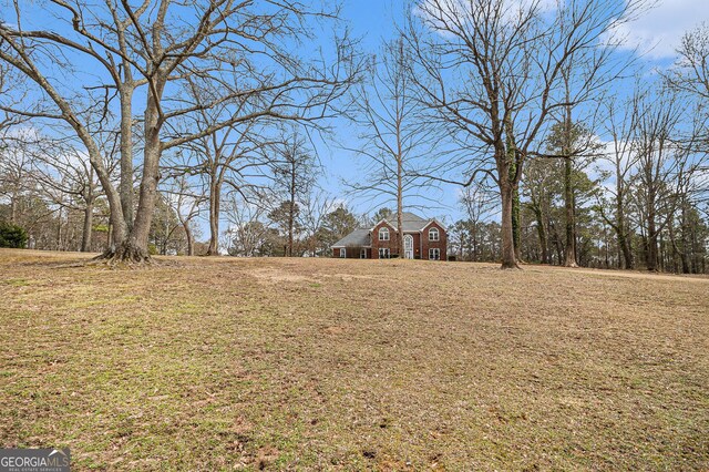 birds eye view of property featuring a view of trees