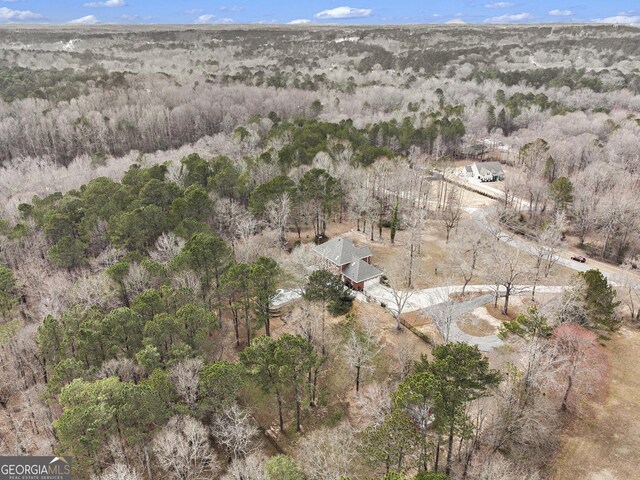 birds eye view of property featuring a view of trees