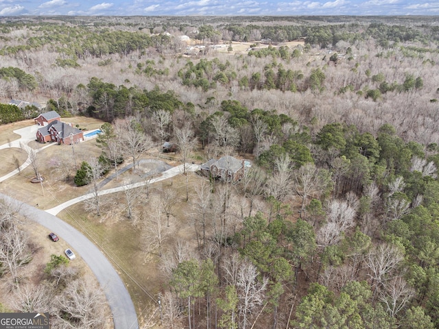 birds eye view of property with a wooded view