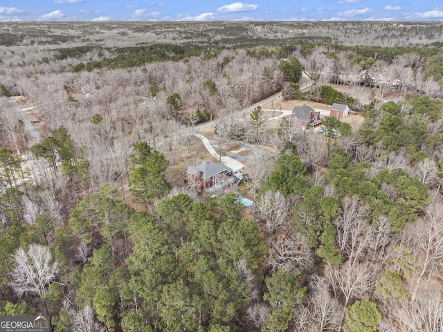 birds eye view of property with a wooded view