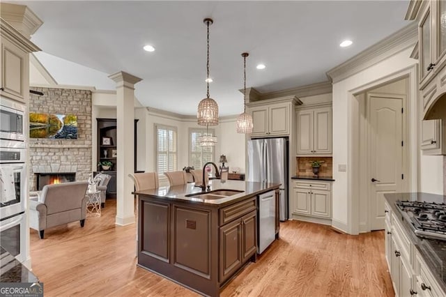 5861 Yoshino Cherry Ln, Braselton, GA 30517 - kitchen with pendant lighting, cream cabinets, stainless steel appliances, and sink