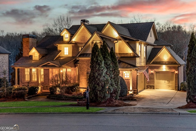 5861 Yoshino Cherry Ln, Braselton, GA 30517 - craftsman inspired home featuring a chimney, concrete driveway, a standing seam roof, and a shingled roof