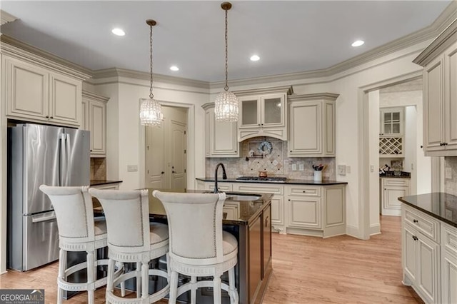5861 Yoshino Cherry Ln, Braselton, GA 30517 - kitchen featuring appliances with stainless steel finishes, decorative light fixtures, sink, and cream cabinetry