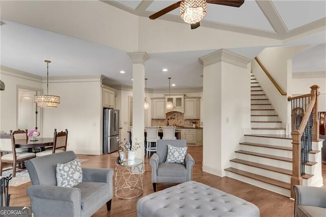 5861 Yoshino Cherry Ln, Braselton, GA 30517 - living room with lofted ceiling, ornate columns, wood-type flooring, ornamental molding, and ceiling fan