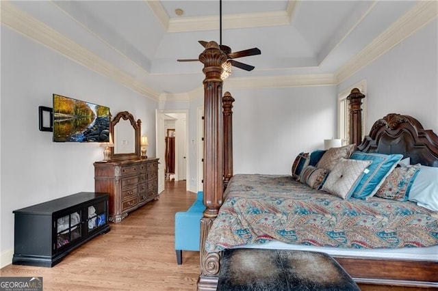 5861 Yoshino Cherry Ln, Braselton, GA 30517 - bedroom featuring crown molding, ceiling fan, light hardwood / wood-style floors, and a tray ceiling