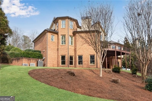 5861 Yoshino Cherry Ln, Braselton, GA 30517 - back of property with a wooden deck, a yard, and central air condition unit