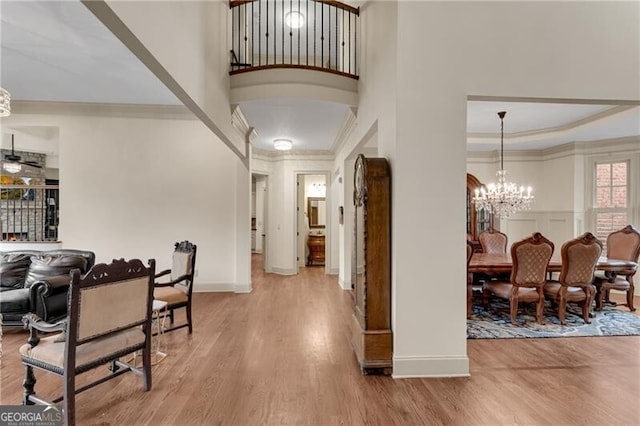 5861 Yoshino Cherry Ln, Braselton, GA 30517 - entrance foyer featuring hardwood / wood-style flooring, ornamental molding, a high ceiling, and ceiling fan with notable chandelier