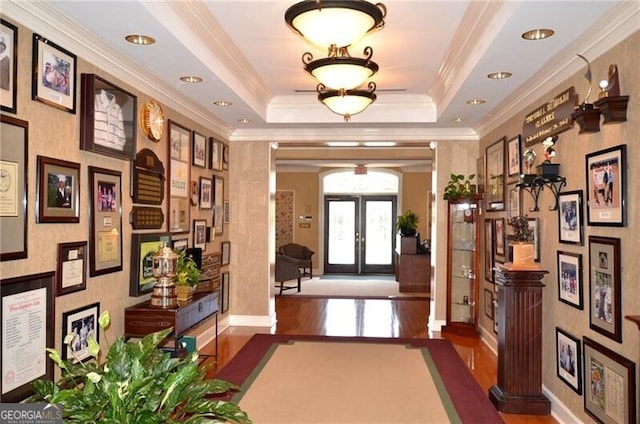 5861 Yoshino Cherry Ln, Braselton, GA 30517 - interior space featuring a tray ceiling, crown molding, dark hardwood / wood-style floors, and french doors