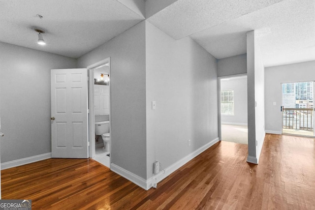 interior space with dark hardwood / wood-style floors and a textured ceiling