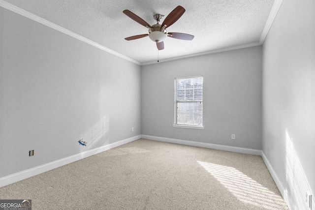 empty room featuring crown molding, ceiling fan, carpet flooring, and a textured ceiling