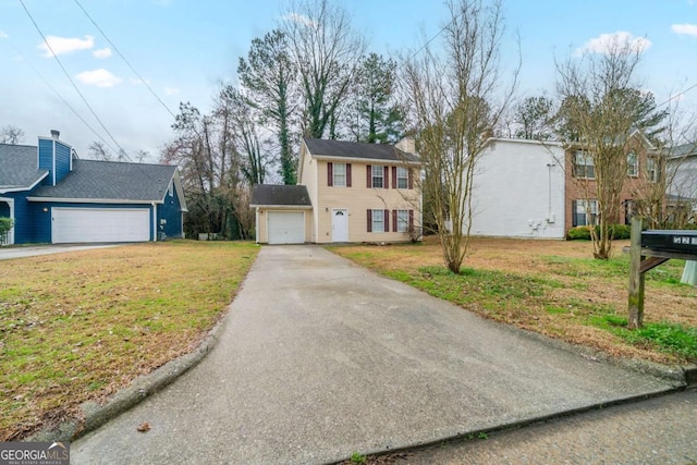 view of front of home featuring a garage and a front lawn