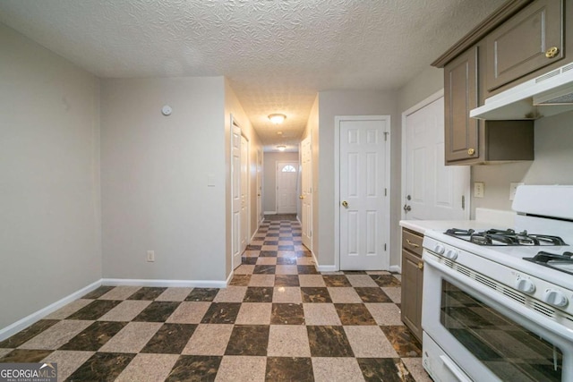 kitchen featuring a textured ceiling and white gas range oven