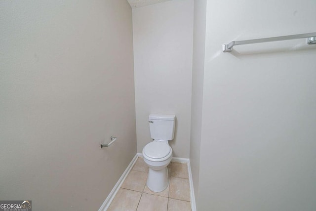 bathroom with tile patterned floors and toilet