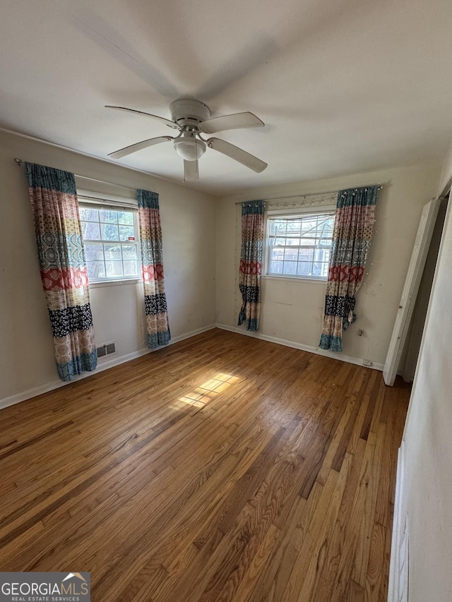 unfurnished bedroom featuring hardwood / wood-style flooring and ceiling fan