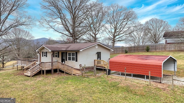 exterior space featuring a carport, a yard, and a mountain view