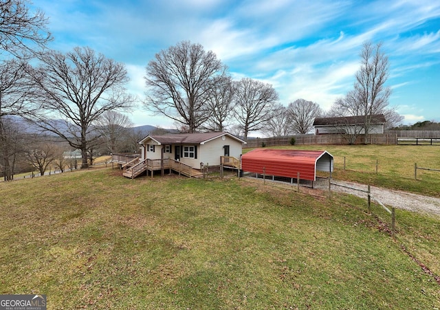 view of yard featuring a deck and a rural view