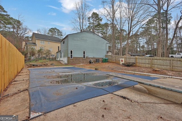 view of swimming pool featuring cooling unit and fence private yard