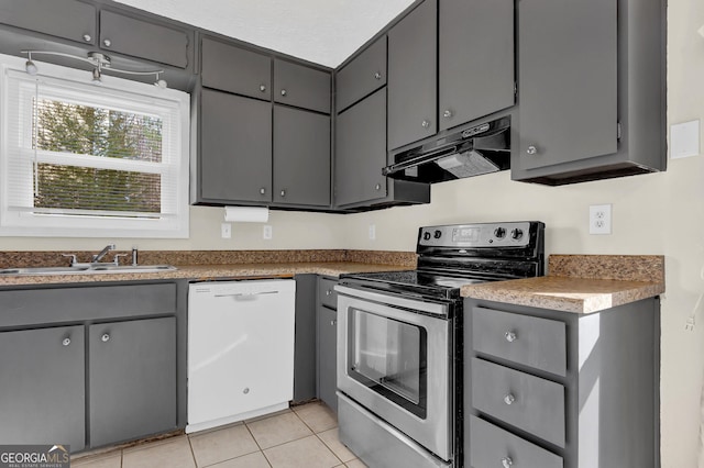 kitchen with electric range, gray cabinetry, a sink, dishwasher, and under cabinet range hood