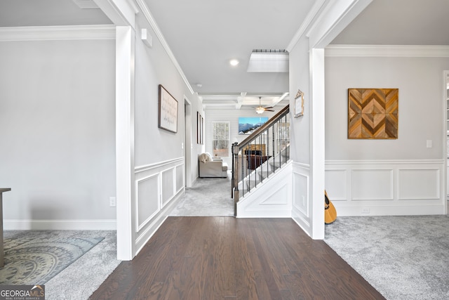 carpeted entrance foyer featuring ornamental molding