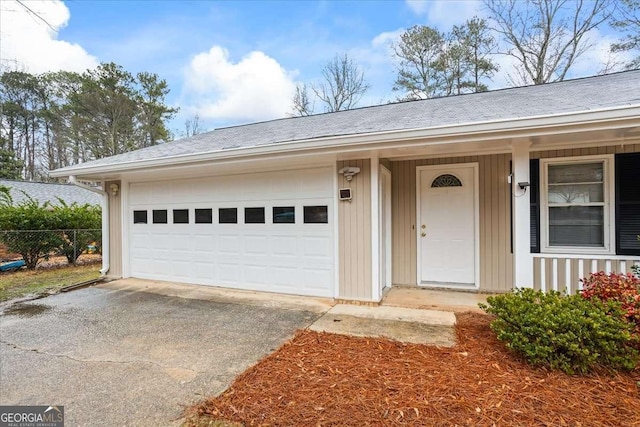 view of exterior entry with a garage