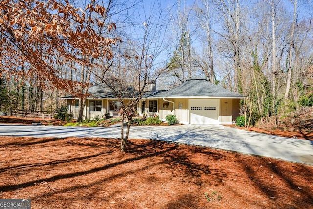 ranch-style home with an attached garage and driveway