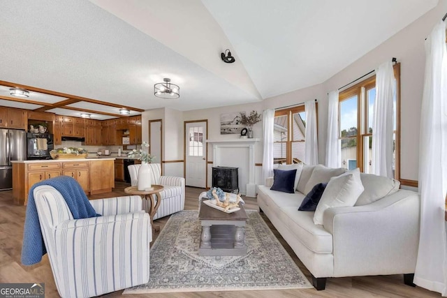 living room with lofted ceiling and light hardwood / wood-style flooring