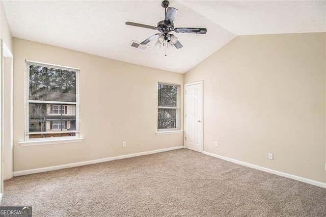 spare room featuring ceiling fan, lofted ceiling, and carpet floors