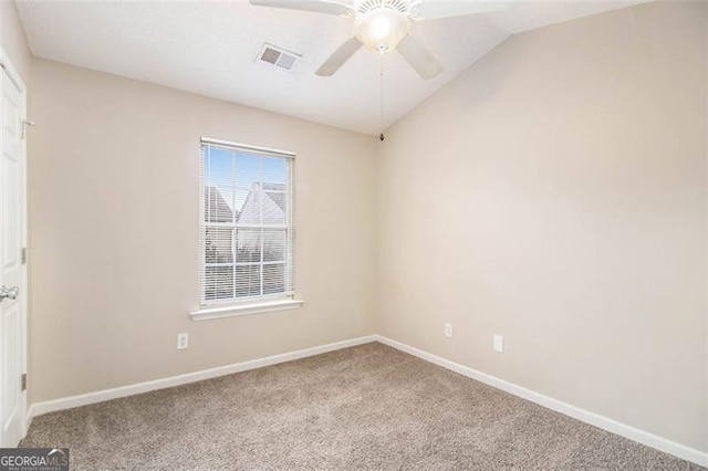 carpeted spare room with lofted ceiling and ceiling fan