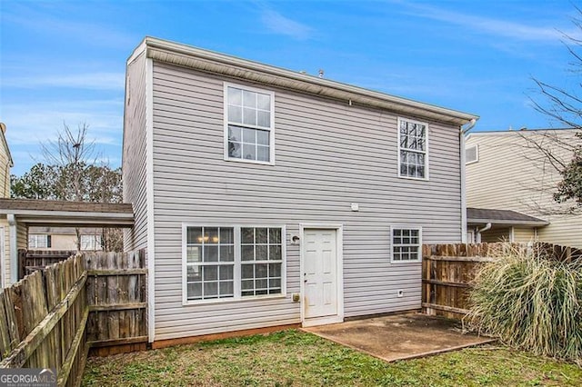 back of property featuring a patio and a yard