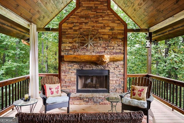 deck featuring an outdoor stone fireplace