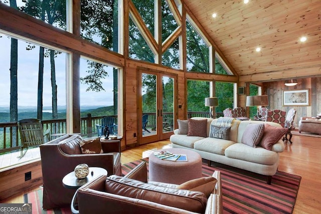 sunroom / solarium with wooden ceiling, french doors, and a water view