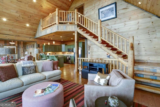 living room with high vaulted ceiling, hardwood / wood-style flooring, wooden ceiling, and wood walls