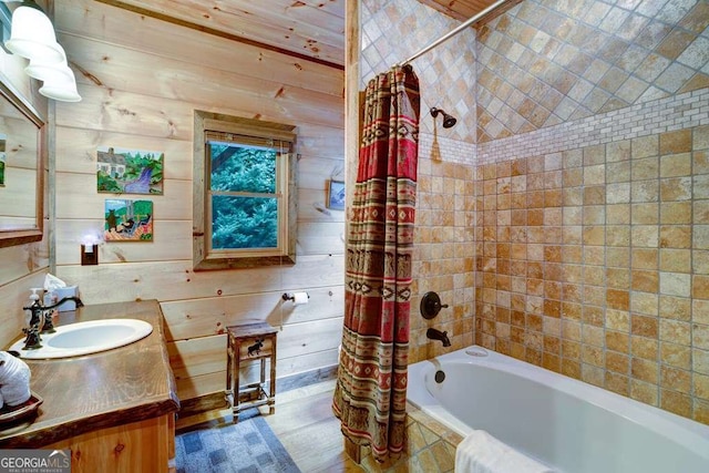 bathroom with vanity, wooden walls, and shower / tub combo