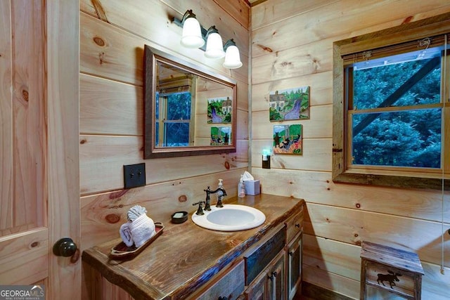 bathroom with vanity and wooden walls