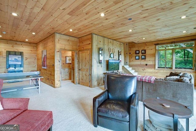 carpeted living room featuring wood ceiling and wooden walls