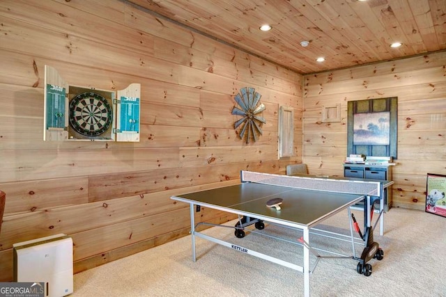 rec room featuring light colored carpet, wooden ceiling, and wooden walls