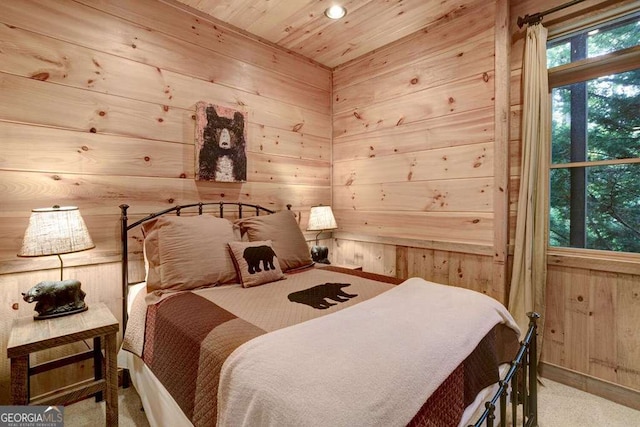 bedroom with wood ceiling and wooden walls