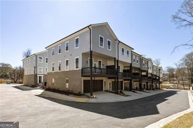 view of building exterior featuring a residential view and an attached garage