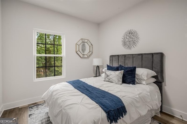bedroom with wood finished floors and baseboards