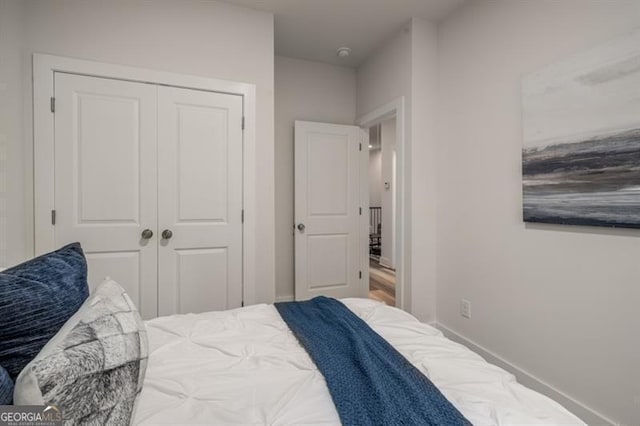 bedroom with a closet and baseboards