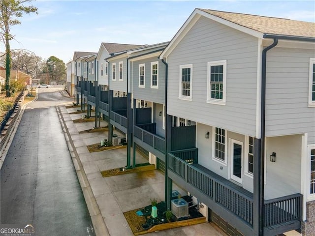 view of side of property with a residential view and central AC unit