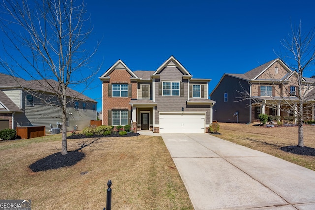 view of front of property featuring a garage, brick siding, driveway, and a front lawn